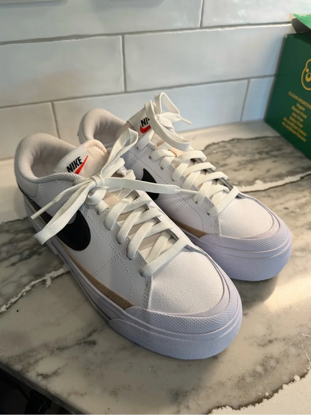 Nike Women’s White Sneakers with Black Swoosh and Tan Accent